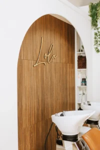 Lola Beauty Boutique hair salon interior with gold signage in Dorchester, MA