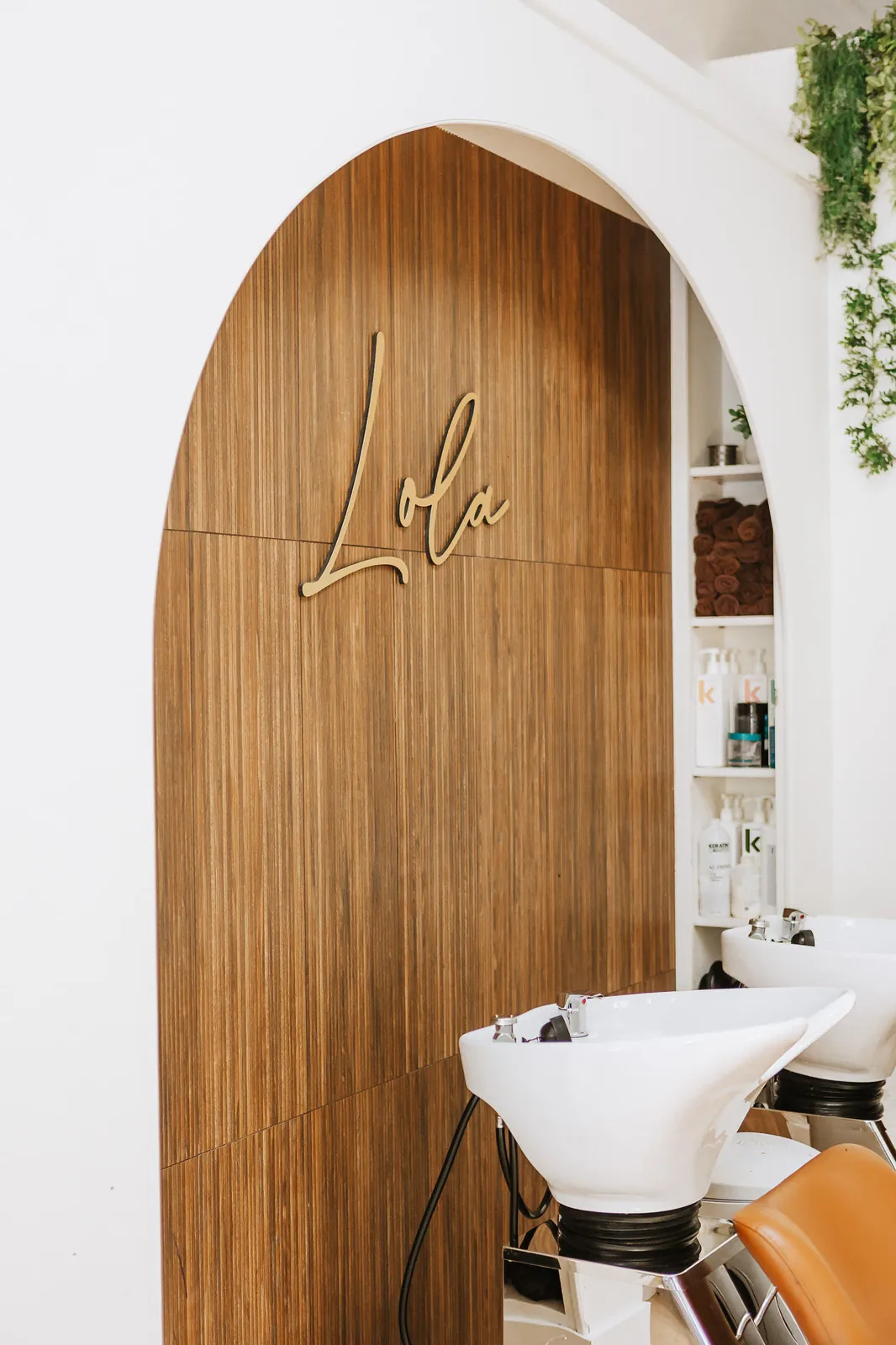 Lola Beauty Boutique hair salon interior with gold signage in Dorchester, MA